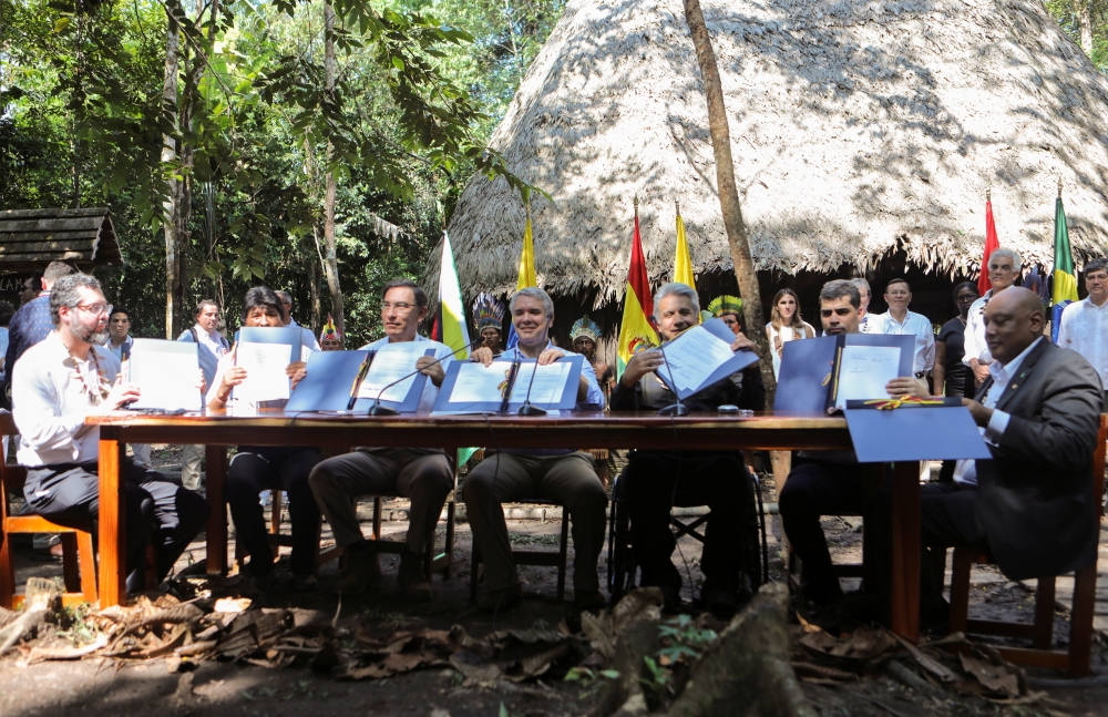 Brazil's Foreign Minister Ernesto Araujo, Bolivia's President Evo Morales, Peru's President Martin Vizcarra, Colombia's President Ivan Duque, Ecuador's President Lenin Moreno, Suriname's Vice President Michael Ashwin Adhin and Guyana's Minister of Natural Resources, Raphael Trotman, show the signed pact for the Amazon during the Presidential Summit for the Amazon, in Leticia, Colombia on Friday. -Reuters