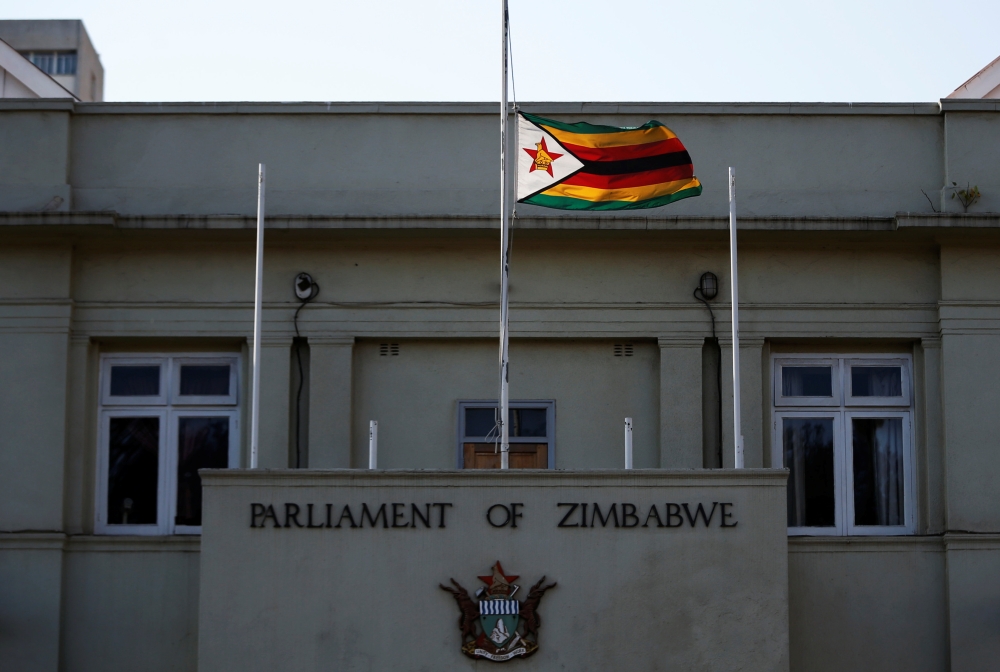A flag is flown at half of a mast outside Paliament as Zimbabweans mourn the death of their founding father Robert Mugabe in Harare, Zimbabwe, on Saturday. -Courtesy photo