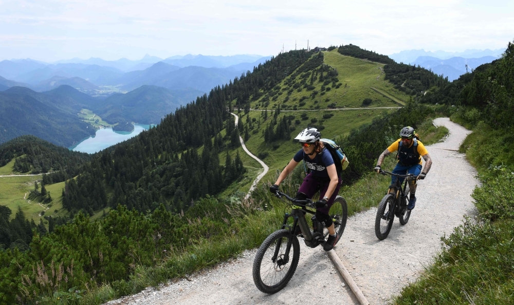 This file photo taken on August 5, 2019 shows Ursula and Robert Werner cycling on their electric bikes as they are on their way up to the Herzogstand mountain in the Alp mountains near the village Walchensee, southern Germany. -AFP