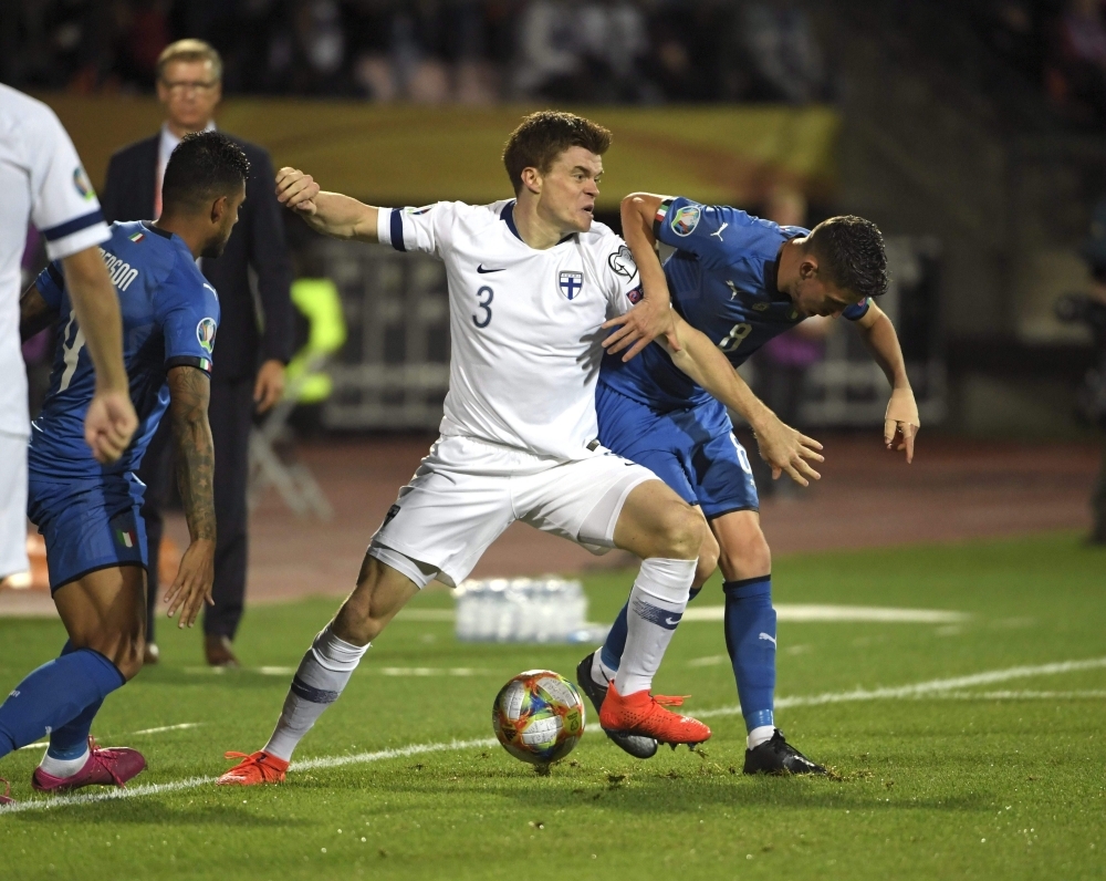 Italy's midfielder Jorginho and Finland's defender Albin Granlund vie for the ball during the UEFA Euro 2020 Group J qualification football match Finland vs Italy in Tampere, Finland, on Sunday. — AFP