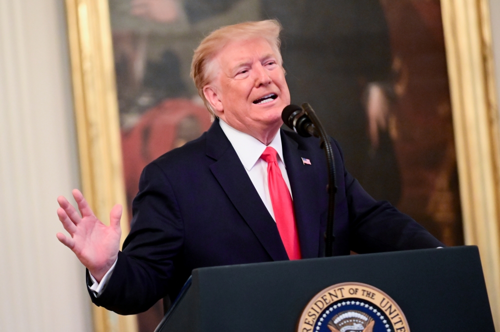US President Donald Trump participates in a presentation ceremony of the Medal of Valor and heroic commendations to civilians and police officers who responded to mass shootings in Dayton, Ohio and El Paso, Texas during a ceremony in the East Room of the White House in Washington, on Monday. — Reuters