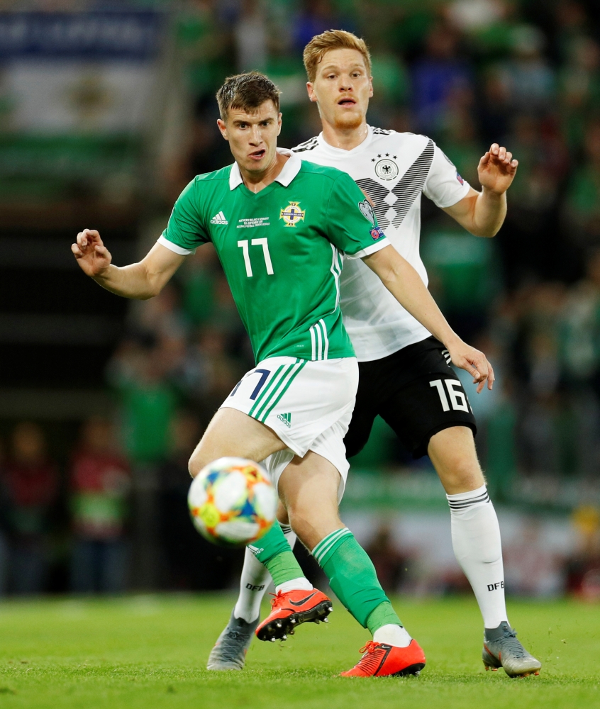 Northern Ireland's Paddy McNair in action with Germany's Marcel Halstenberg during Euro 2020 Qualifier Group C game at Windsor Park, Belfast, Britain, on Monday. —  Reuters
