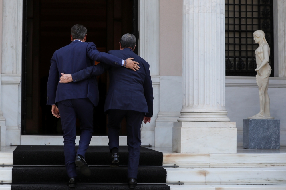 Greek Prime Minister Kyriakos Mitsotakis welcomes Cypriot President Nicos Anastasiades at the Maximos Mansion in Athens, Greece, on Tuesday. — Reuters
