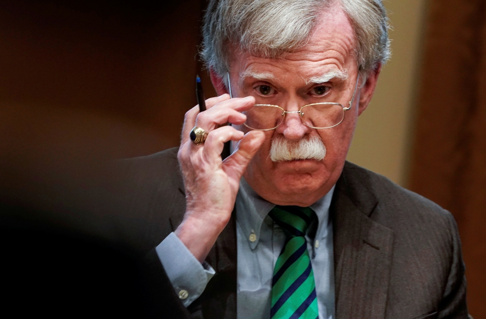 National Security Adviser John Bolton adjusts his glasses as US President Donald Trump speaks while meeting with NATO Secretary General Jens Stoltenberg in the Oval Office at the White House in Washington, in this April 2, 2019 file photo. — Reuters
