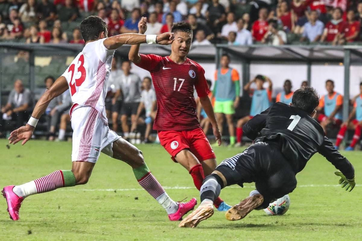 Hong Kong’s Law Tsz-chun takes on the Iran defense during Tuesday night’s FIFA Asia World Cup qualifier at Hong Kong Stadium. — Courtesy photo