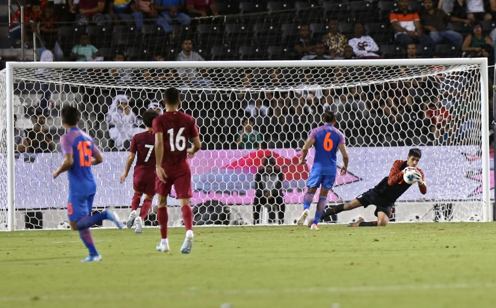 India's goalkeeper Gurpreet Singh Sandhu (R) saves the ball during the FIFA world cup Qatar 2022 and AFC Asian cup China 2023 preliminary joint qualification round 2 match between Qatar and India, at the Jassim Bin Hamad Stadium in Doha, on Tuesday. — AFP