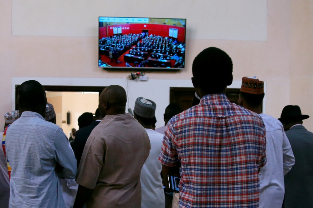 People watch on-screen an election tribunal that is due to rule on an opposition candidate's bid to overturn a result at the Court of Appeal in Abuja, Nigeria, on Wednesday. — Reuters