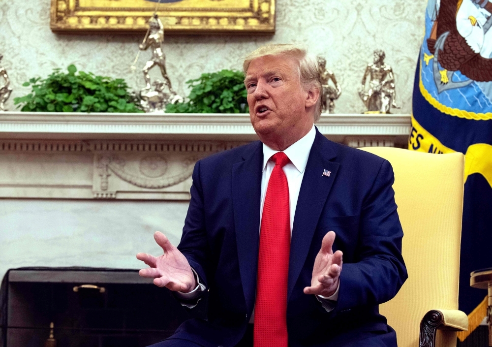 US President Donald Trump speaks to the press in the Oval Office at the White House in Washington on Wednesday. — AFP