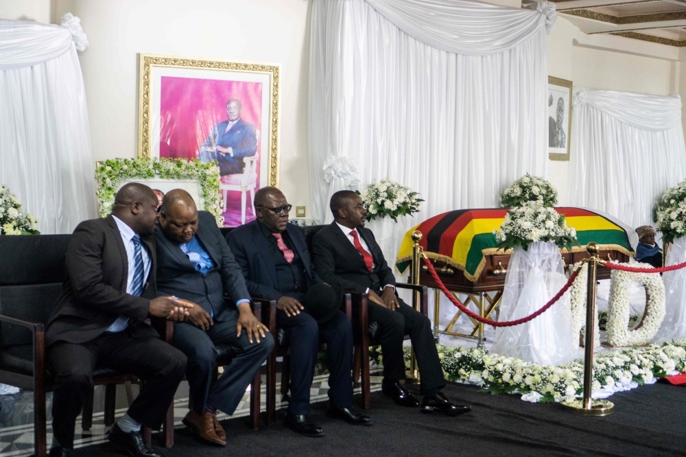 Movement for Democratic Change party leader Nelson Chamisa (R), vice-president Tendai Biti (2ndR) and vice-Chairman Job Sikhala (2ndL) attend the lying in state of Zimbabwe's late president Robert Mugabe at the Mugabe's Blue Roof residency in Harare on Thursday.  Mugabe, whose autocratic rule ended in a military coup in 2017, died on Sept. 6, 2019 at the age of 95. — AFP