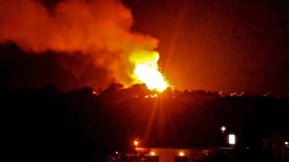 A grab taken from a video provided by a guest of the Acapulco hotel in Kyrenia (Girne) in the self-proclaimed Turkish Republic of Northern Cyprus (TRNC), north of the divided Cypriot capital Nicosia, shows fire and smoke billowing from the site of a military depot which exploded nearby, on Wednesday. — AFP