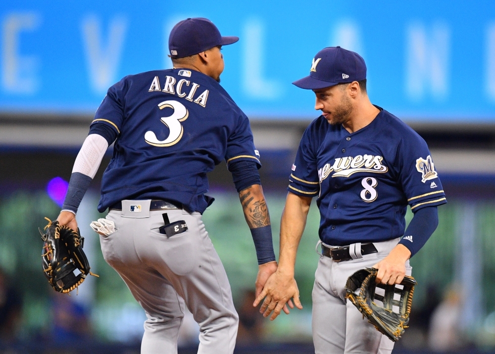 Orlando Arcia No. 3 and Ryan Braun No. 8 of the Milwaukee Brewers celebrate the win against the Miami Marlins at Marlins Park on Thursday in Miami, Florida.   — AFP