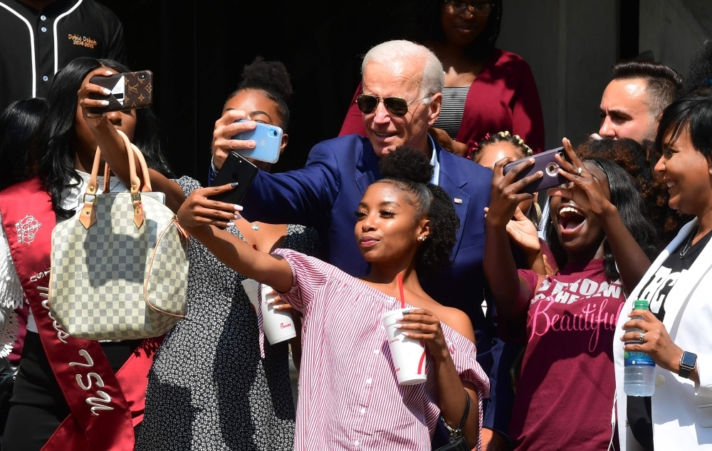 Democratic 2020 presidential hopeful former Vice President Joe Biden poses for selfies while visiting with students at Texas Southern University Student Life Center in Houston, Texas on Friday. -Courtesy photo