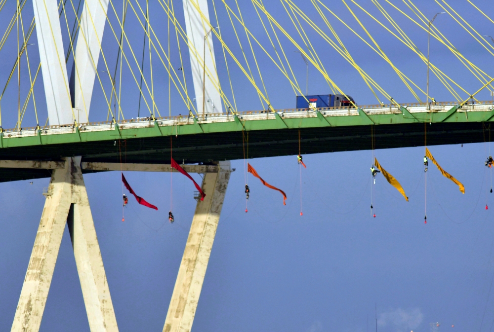 Greenpeace USA climbers form a blockade on the Fred Hartman Bridge, shutting down the Houston Ship Channel, the largest fossil fuel thoroughfare in the United States, ahead of the third Democratic primary debate in nearby Houston, near Baytown, Texas, on Thursday. -Reuters