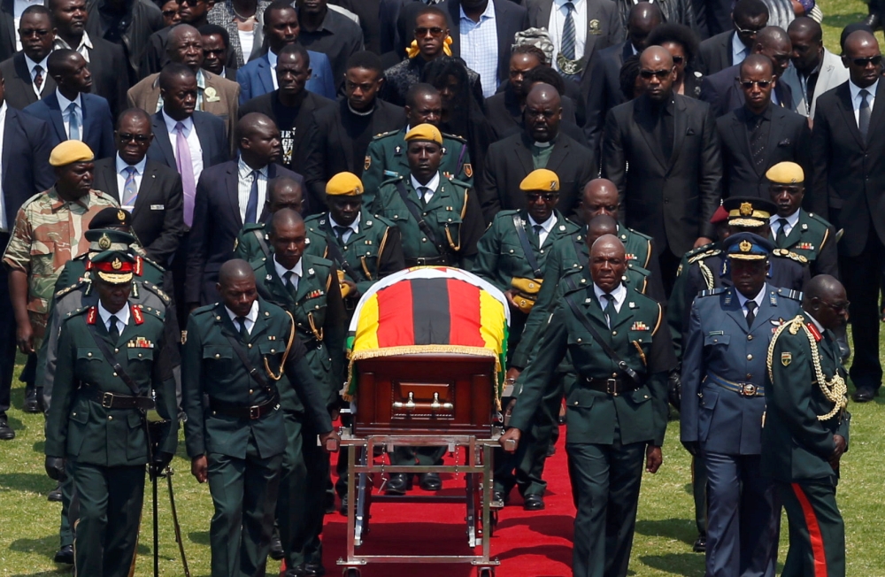 The body of Zimbabwe's founder and longtime ruler Robert Mugabe is brought to the national sports stadium for a state funeral in Harare, Zimbabwe on Saturday. -Reuters