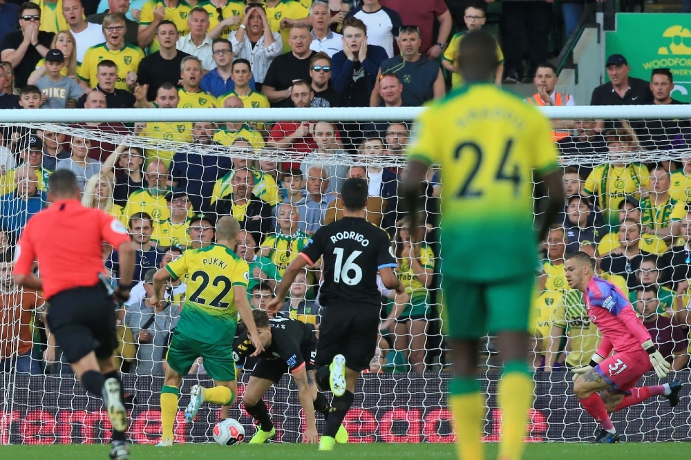 Norwich City's Finnish striker Teemu Pukki (2nd L) sets himself before scoring their third goal during the English Premier League football match between Norwich City and Manchester City at Carrow Road in Norwich, eastern England on Saturday. — AFP