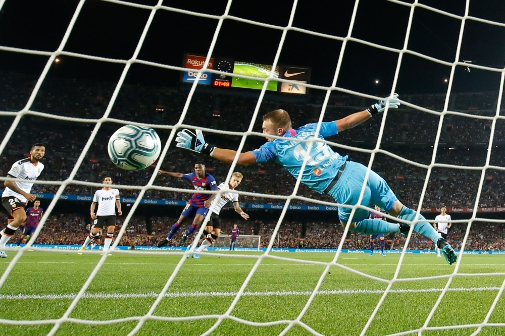 Valencia's Dutch goalkeeper Jasper Cillessen fails to catch a goal scored by Barcelona´s Guinea-Bissau forward Ansu Fati (C) during the Spanish league football match FC Barcelona against Valencia CF at the Camp Nou stadium in Barcelona, on Saturday. — AFP