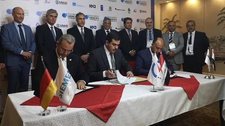 From (L to R) Karim Amin, CEO of Siemens Power Generation, Waleed Khaled Hassan, director general, general state company for electricity production north region and Orascom CEO Osama Bishai, sign a contract in the Iraqi capital Baghdad on Saturday. Iraq today signed a $1.3 billion deal with German energy company Siemens and its partner Orascom Construction to rebuild a major power plant complex in the country's ravaged city of Baiji, north of Baghdad. — AFP