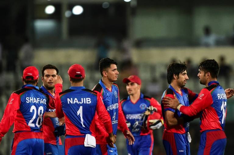 Afghanistan players celebrate after winning their second match against Bangladesh during the tri-nation Twenty20 international tournament in Dhaka on Sunday. — AFP