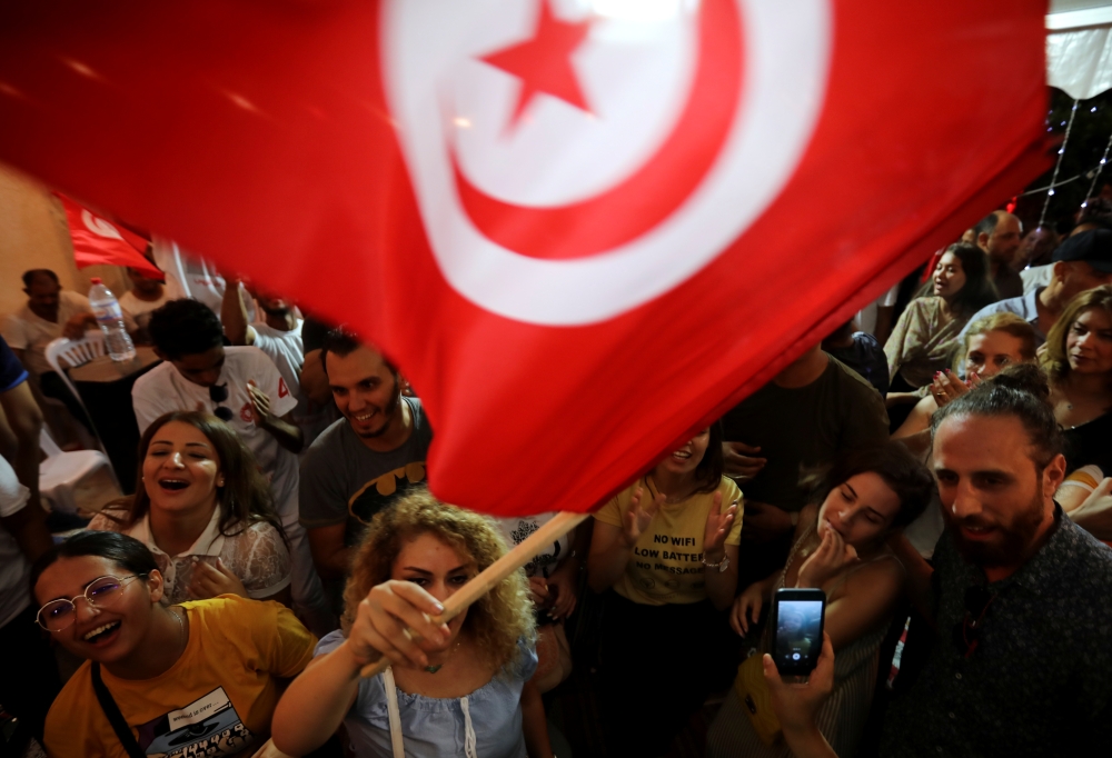 Supporters of detained presidential candidate and Tunisian media mogul Nabil Karoui react after unofficial results of the Tunisian presidential election in Tunis, Tunisia, on Sunday. -Reuters