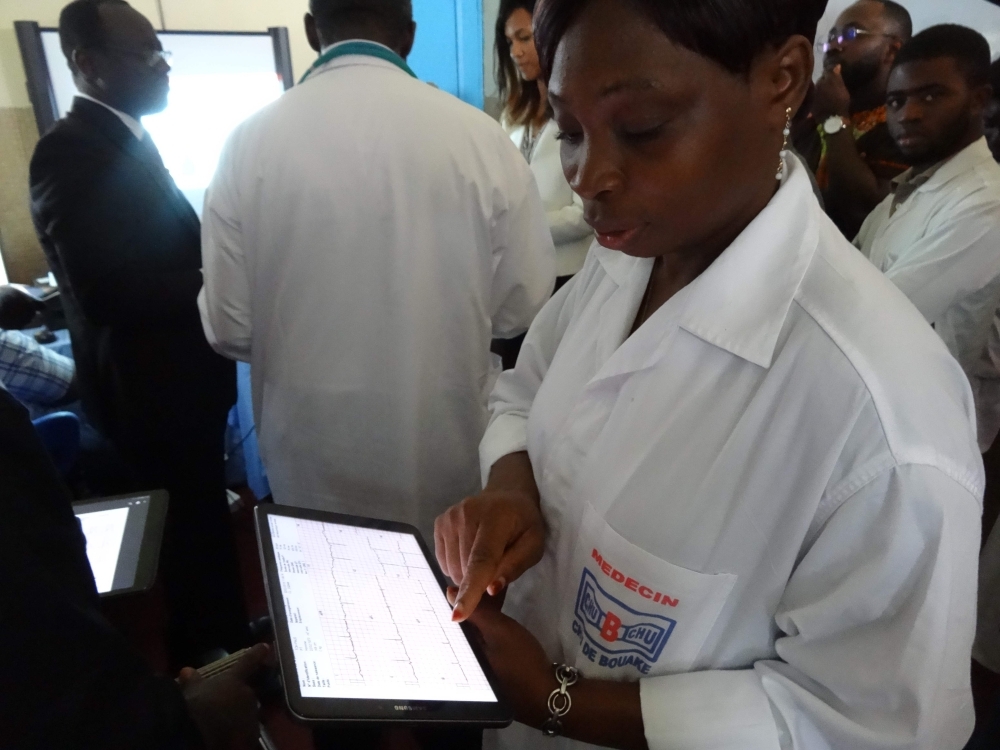 An Ivorian doctor uses a tablet computer in Bouake hospital's trailblazer telemedicine departement for heart diseases, in Bouake on June 20, 2019. -AFP