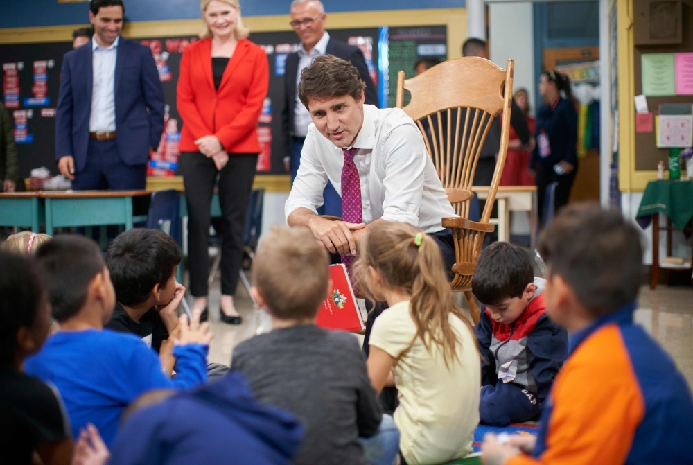 Canadian Prime Minister Justin Trudeau reads a story to Grade 1 and 2 students at a campaign stop at Blessed Sacrament Catholic Elementary School in London, Ontario on Monday. Polls showed Trudeau, once the youthful golden boy of Canadian politics, in a horse race with Conservative Andrew Scheer, who launched his bid for leadership by accusing the Liberal prime minister of lying 