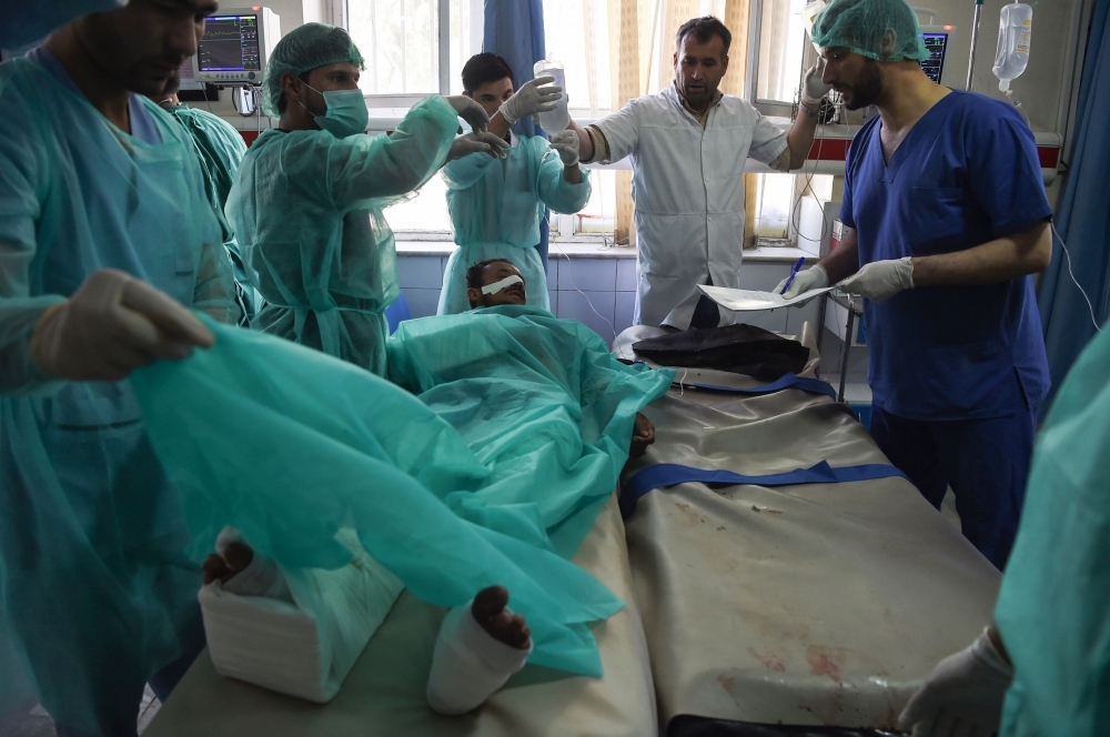 A wounded Afghan man receives treatment at the Wazir Akbar Khan hospital following a blast in Kabul on Tuesday. -AFP