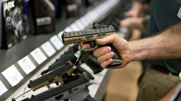 An attendee holds a Fabbrica d’Armi Pietro Beretta SpA pistol at the company’s booth during the National Rifle Association annual meeting in Dallas, Texas, in this May 5, 2018 file picture. — Courtesy photo
