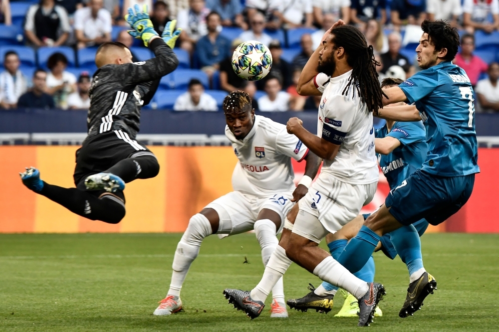 Lyon's Portuguese goalkeeper Anthony Lopes (L) jumps to save the ball in front of Lyon's Malian defender Youssouf Kone (C), Lyon's Belgian defender Jason Denayer and Zenit St. Petersburg's Iranian forward Sardar Azmoun (R) during the European Champions League football match between Olympique Lyonnais (OL) and Zenit Saint-Petersburg in Decines-Charpieu, near Lyon, on Tuesday. — AFP