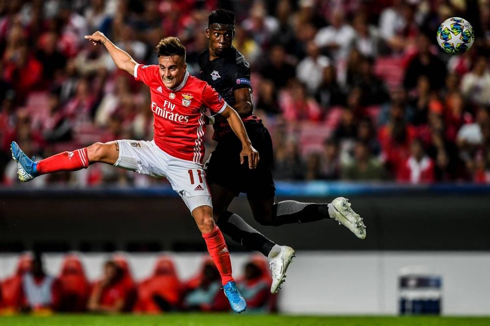 Benfica's Argentine forward Franco Cervi (L) heads the ball with Leipzig's French defender Nordi Mukiele (R)  during the UEFA Champions League Group G football match SL Benfica against RB Leipzig at Luz Stadium in Lisbon, on Tuesday. — AFP