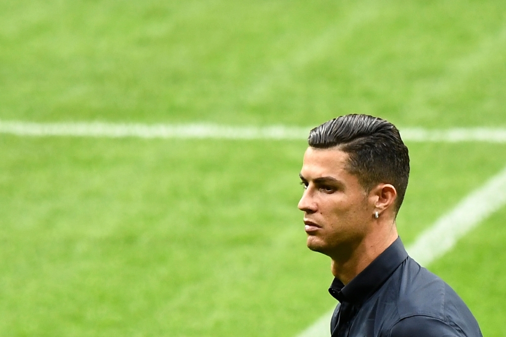 Juventus' Portuguese forward Cristiano Ronaldo walks around the Wanda Metropolitano stadium in Madrid on Tuesday on the eve of the UEFA Champions League Group D football match against Atletico de Madrid. — AFP