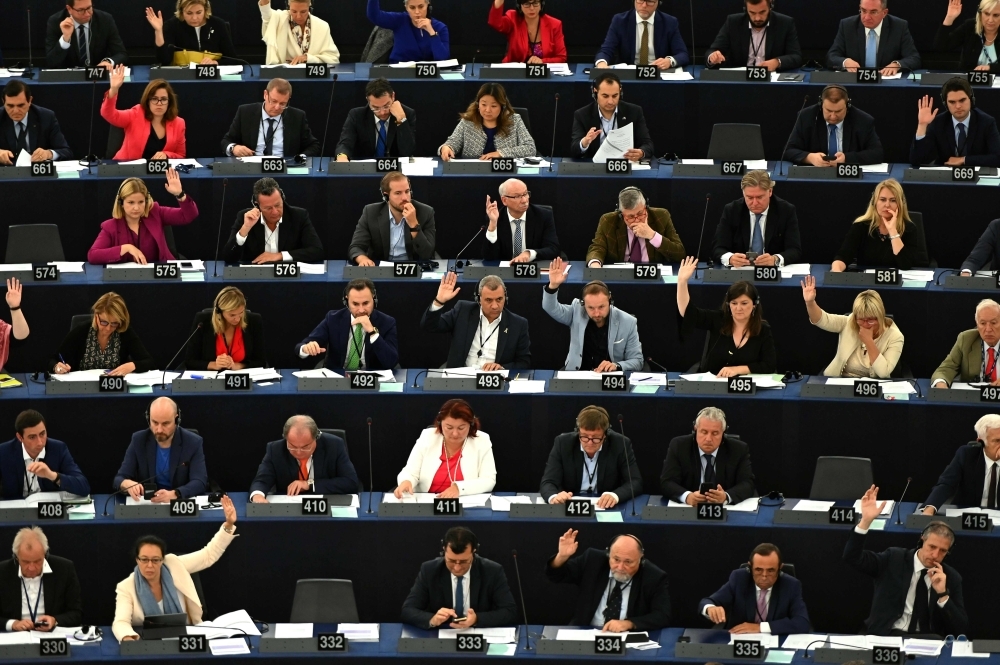 Euro-deputies vote during a plenary session following a debate on Brexit at the European Parliament in Strasbourg, northeastern France, on Wednesday. — AFP