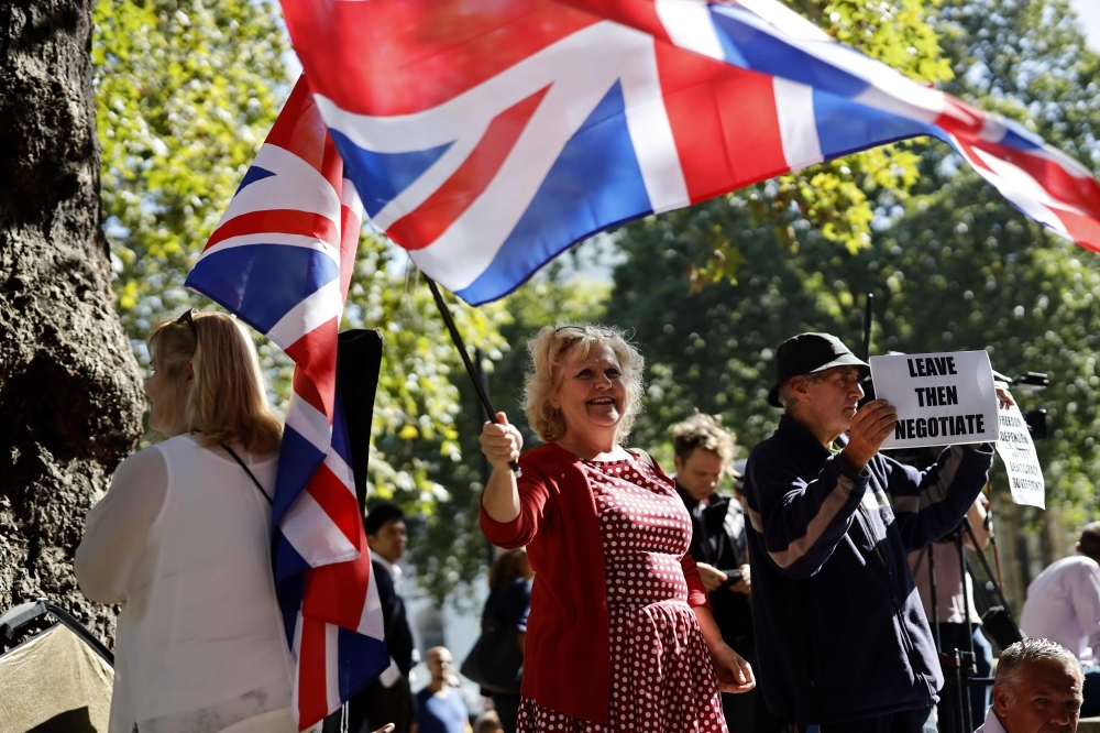 Pro-Brexit demonstrators wave the Union flag and hold placards outside the Supreme Court in central London, on the second day of the hearing into the decision by the government to prorogue parliament on Wednesday. — AFP
