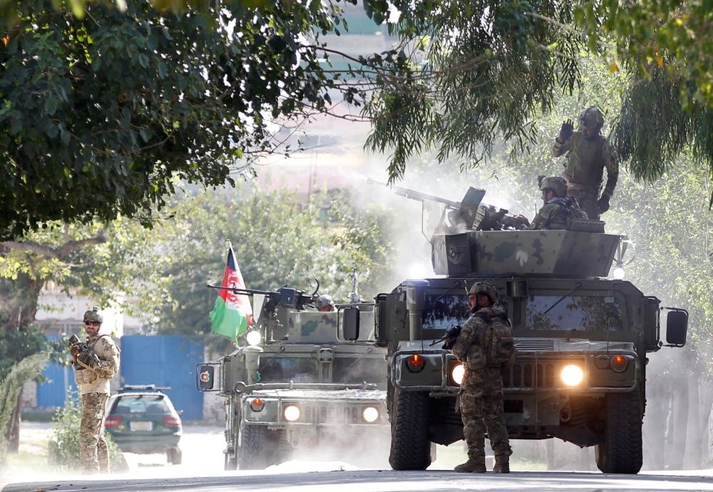 Afghan security forces fires heavy machine-gun at insurgents near the site of an attack in Jalalabad city, Afghanistan Wednesday. — Reuters