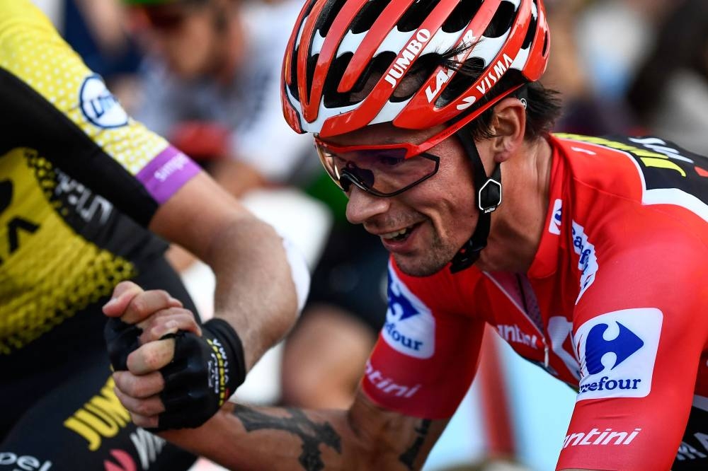 Team Jumbo rider Slovenia's Primoz Roglic is congratulated by teammates at the end of the 21st stage of the 2019 La Vuelta cycling Tour of Spain, a 106,6 km race from Fuenlabrada to Madrid on Sept. 15, 2019. — AFP