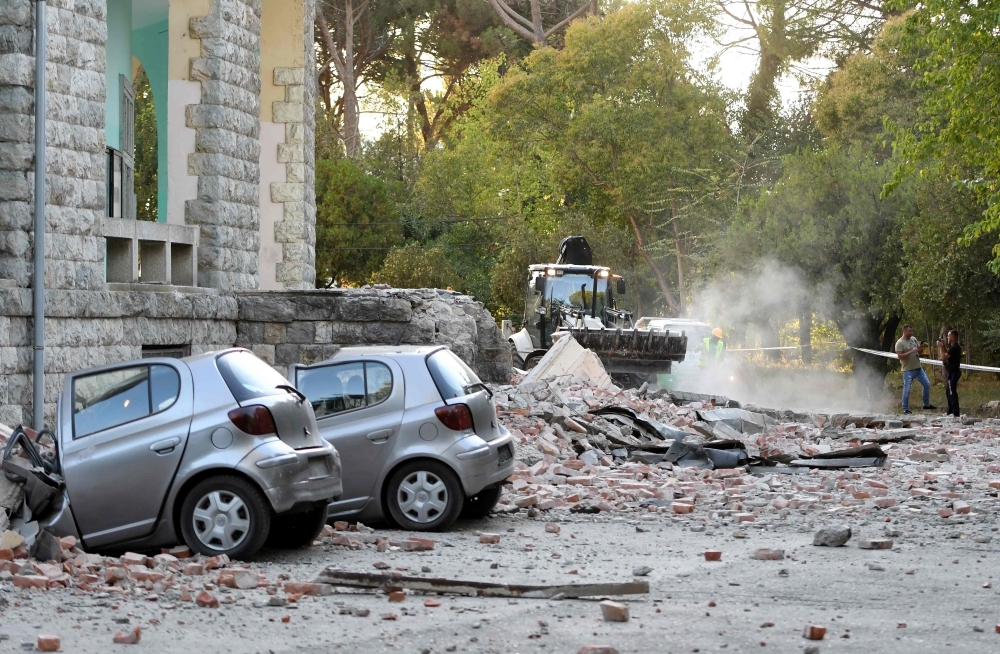 Vehicles are crushes as emergency services workers clear the ruins of a collapsed building roof in Tirana on Saturday, after two earthquakes over 5.0 magnitude struck the Adriatic coastline of Albania. -AFP