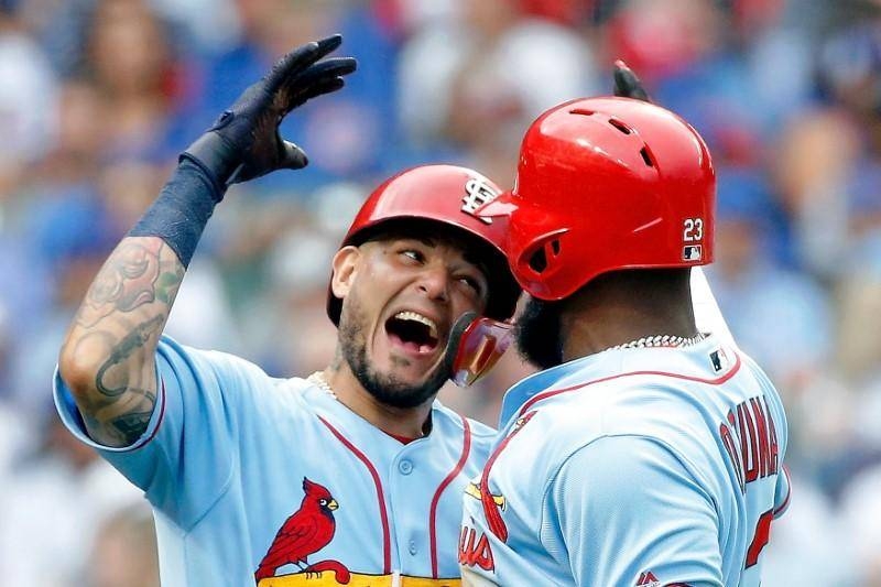 St. Louis Cardinals left fielder Marcell Ozuna (23) celebrates his two run home run against the Chicago Cubs with catcher Yadier Molina (4) during the seventh inning at Wrigley Field in Chicago, IL, USA, on Saturday. — Reuters