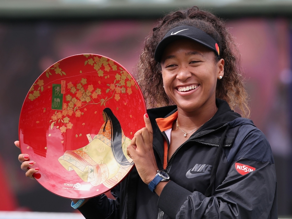 Pan Pacific Open women's singles winner Naomi Osaka holds a victory plate during the awarding ceremony in Osaka, on Sunday. — AFP