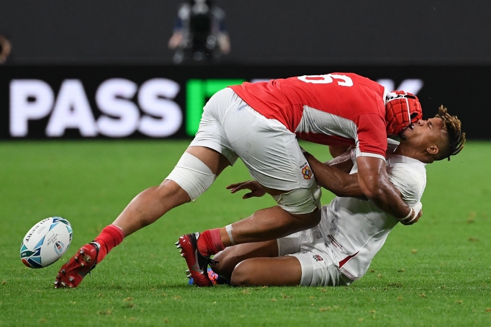 England's wing Anthony Watson (R) is is tackled by Tonga's flanker Sione Kalamafoni  during the Japan 2019 Rugby World Cup Pool C match between England and Tonga at the Sapporo Dome in Sapporo, on Sunday. — AFP