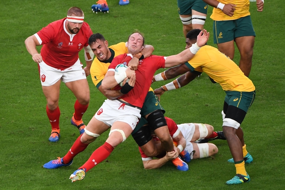 Wales' lock Alun Wyn Jones (C) is is tackled by Australia's lock Rory Arnold (C-L) during the Japan 2019 Rugby World Cup Pool D match between Australia and Wales at the Tokyo Stadium in Tokyo, on Sunday. — AFP