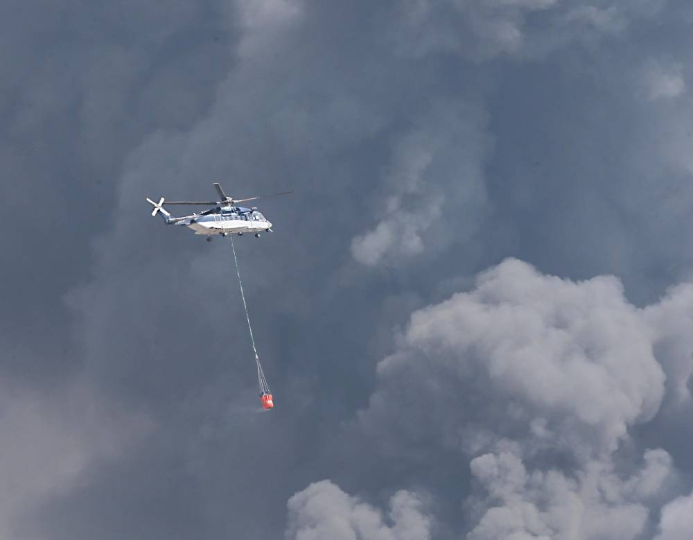 The Civil Defense forces, with the support of helicopters, battled for long hours to put out the fire that engulfed the roof of the Haramain High Speed Rail station in Sulaymaniyah district in Jeddah on Sunday. — Okaz/SG photo by Amr Sallam