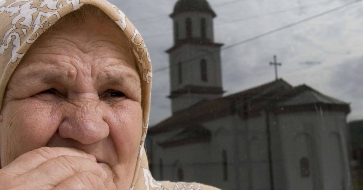 Bosnian Muslim woman Fata Orlovic, 67, gesture as she views the Serb Orthodox church, reflected in window, in the village of Konjevic Polje, 100 km northeast of the Bosnian capital of Sarajevo, in this Oct. 9, 2007 file picture. — Courtesy photo