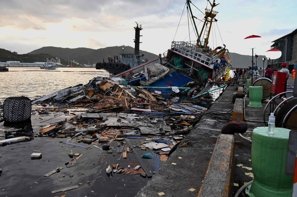 This picture taken on Tuesday shows the wreckage of a fishing boat after a bridge collapsed in the Nanfangao fish harbor in Suao township in Ilan county, eastern Taiwan.   — AFP