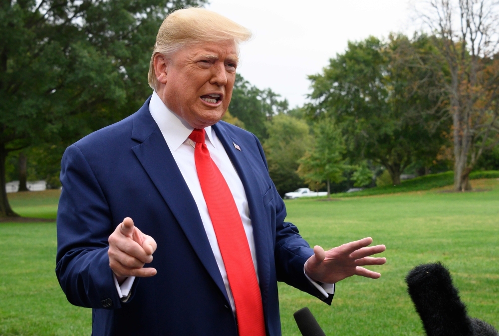 US President Donald Trump speaks to the press as he departs the White House in Washington, DC, for Florida on Thursday. Trump said the US remained committed to resuming nuclear talks with North Korea despite Pyongyang's latest weapons test. 