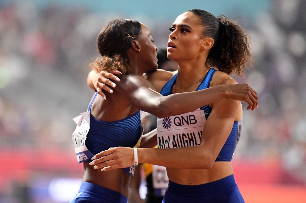 USA's Dalilah Muhammad celebrates after winning and poses next to the screen reading the new world record in the Women's 400m Hurdles final at the 2019 IAAF Athletics World Championships at the Khalifa International stadium in Doha on Friday. — AFP