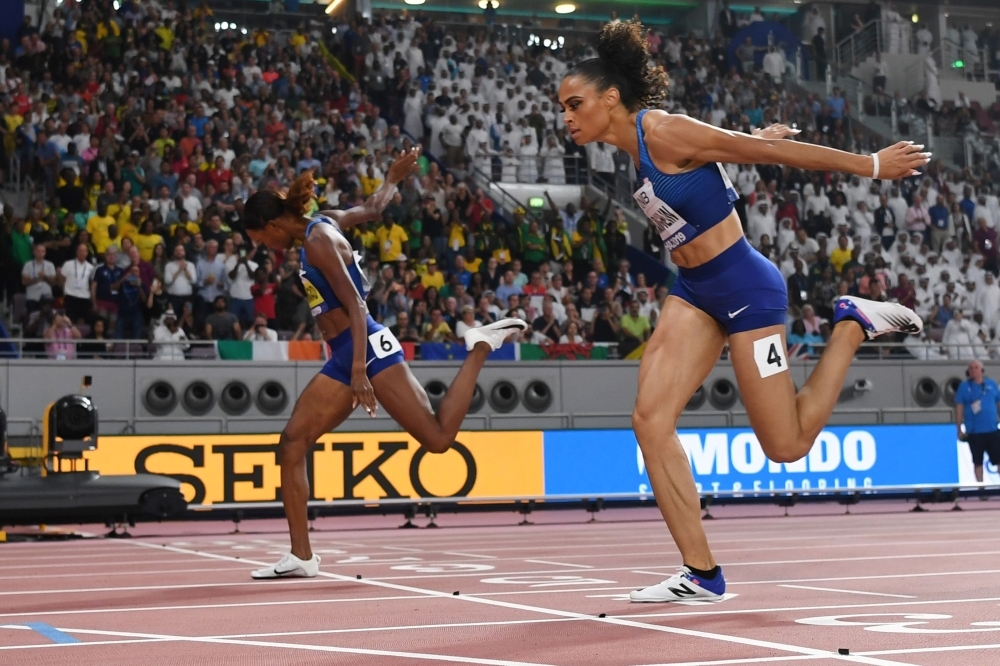 USA's Dalilah Muhammad celebrates after winning and poses next to the screen reading the new world record in the Women's 400m Hurdles final at the 2019 IAAF Athletics World Championships at the Khalifa International stadium in Doha on Friday. — AFP