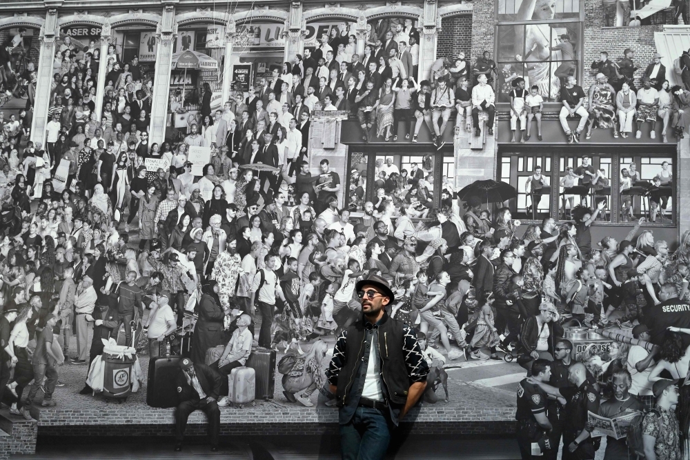  French-born artist JR poses for pictures prior to the opening of his exhibition 