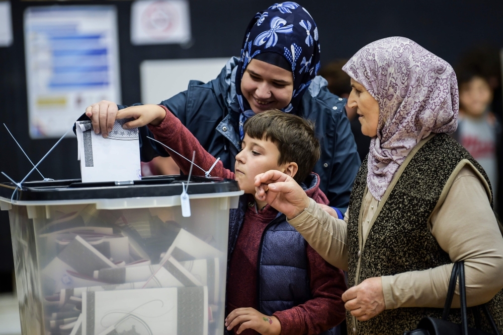 Kosovo Albanians vote for the parliamentary election at a polling station in Pristina on Sunday. Kosovo went to the polls in an election that could usher in new leadership at a time when stalled talks with former war foe Serbia are a source of instability in Europe. — AFP