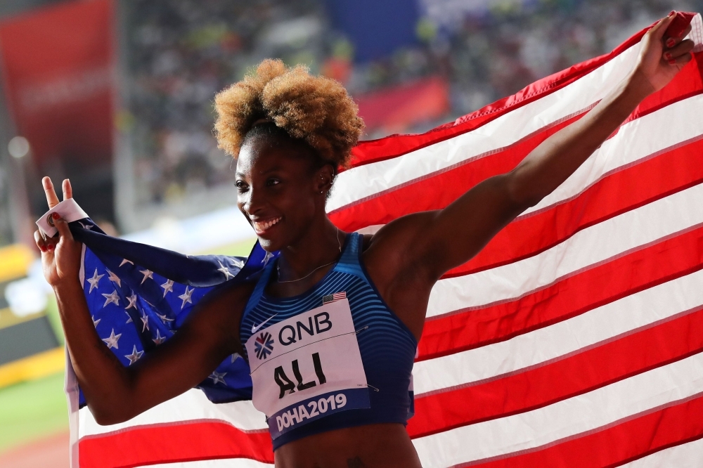 USA's Nia Ali holds the national flag after winning the women's 100m Hhurdles final at the 2019 IAAF Athletics World Championships at the Khalifa International stadium in Doha, on Sunday. — AFP