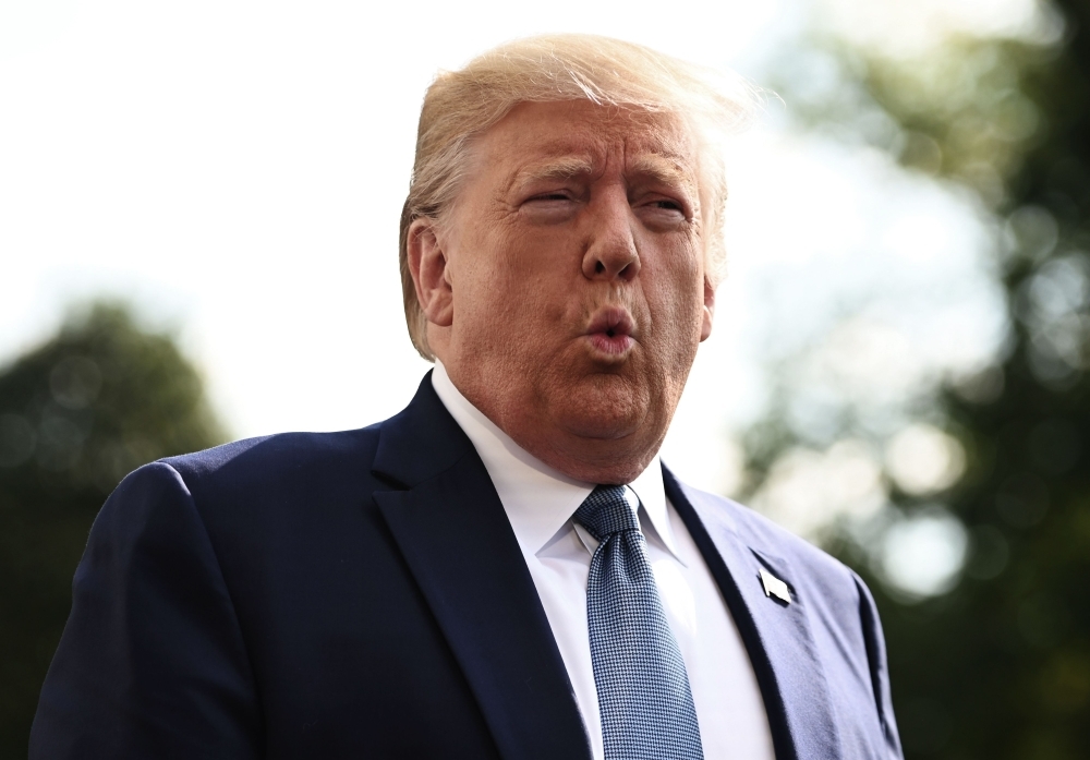 US President Donald Trump speaks to the press as he departs the White House in Washington for his annual visit to Walter Reed National Military Medical Center in this Oct. 4, 2019 file photo. — AFP