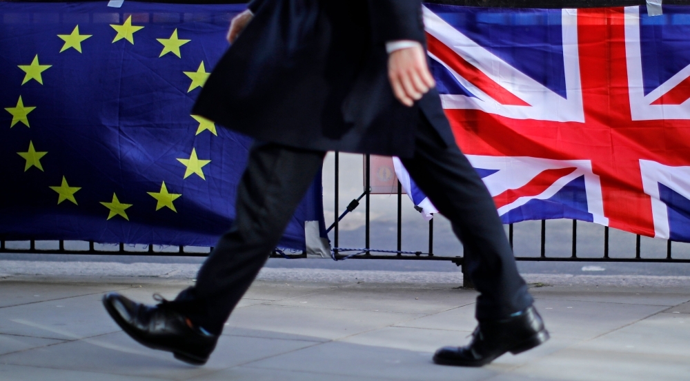 A man walks past the EU and Union flags of anti-Brexit protesters outside the Houses of Parliament in London in this Feb. 12, 2019 file photo. — AFP